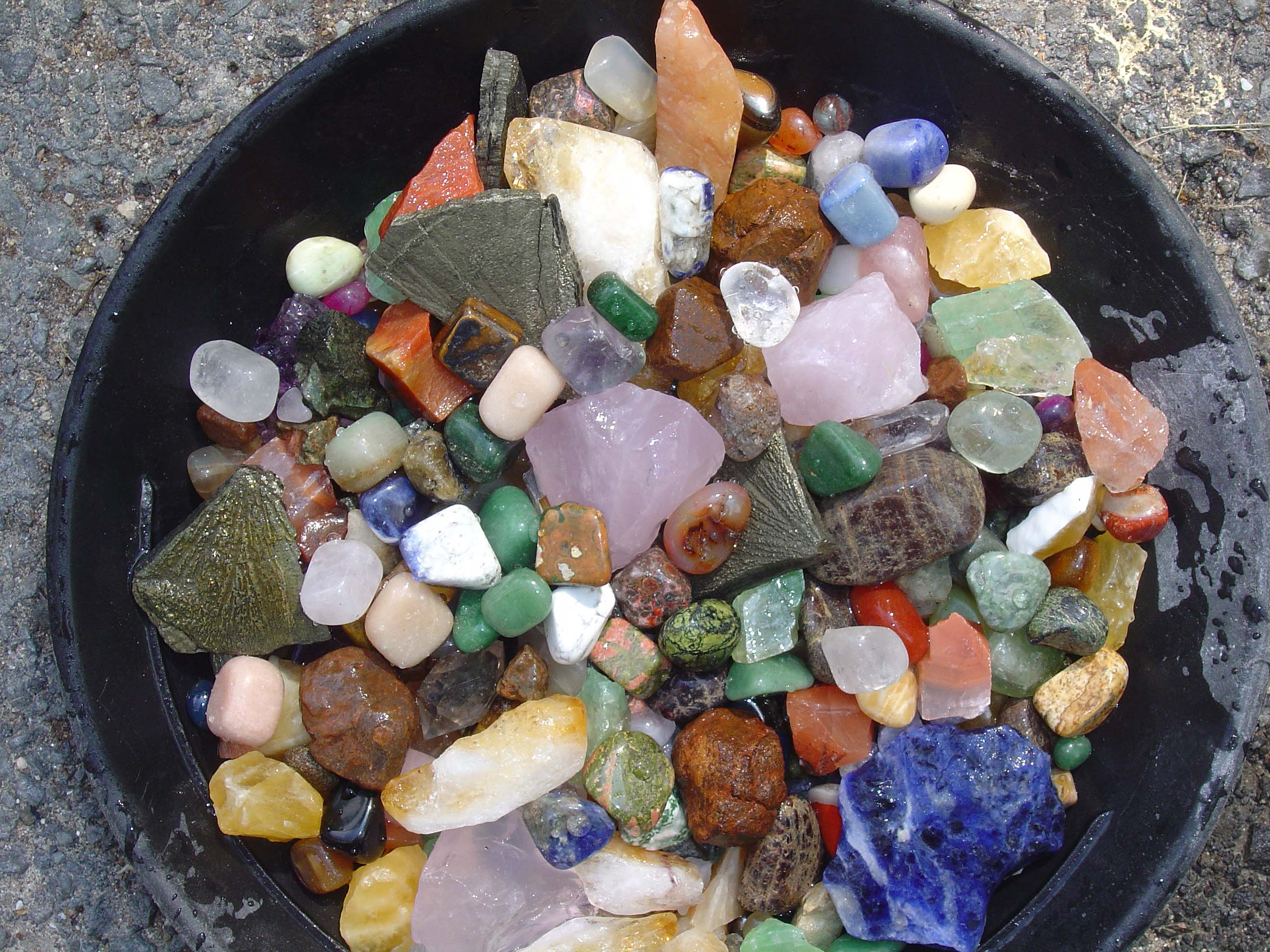 This is a picture of a bowl mixed with rocks and gems.